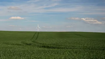 Tramline to a wind turbine in a wheat field.jpg